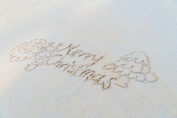 Concept Christmas on the beach Tropical design made in Phuket, Thailand Write the alphabet on the sand background Taken from real locations.