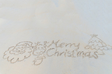 Concept Christmas on the beach Tropical design made in Phuket, Thailand Write the alphabet on the sand background Taken from real locations.