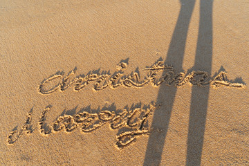 Concept Christmas on the beach Tropical design made in Phuket, Thailand Write the alphabet on the sand background Taken from real locations.