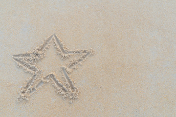 Concept Christmas on the beach Tropical design made in Phuket, Thailand Write the alphabet on the sand background Taken from real locations.