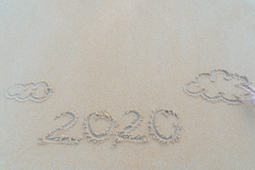 Concept Christmas on the beach Tropical design made in Phuket, Thailand Write the alphabet on the sand background Taken from real locations.