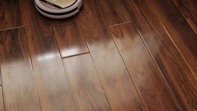 Robot vacuum cleaner cleans the floor from dust. Smart house.