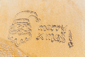 Concept Christmas on the beach Tropical design made in Phuket, Thailand Write the alphabet on the sand background Taken from real locations.