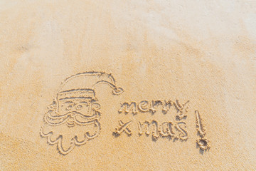 Concept Christmas on the beach Tropical design made in Phuket, Thailand Write the alphabet on the sand background Taken from real locations.