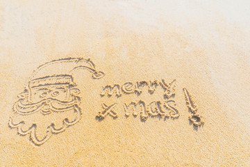 Concept Christmas on the beach Tropical design made in Phuket, Thailand Write the alphabet on the sand background Taken from real locations.