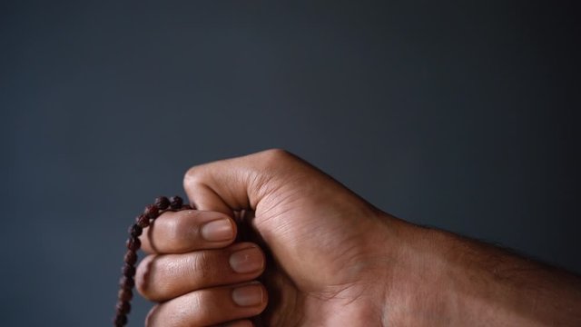 chanting mantra with japa mala close up