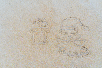 Concept Christmas on the beach Tropical design made in Phuket, Thailand Write the alphabet on the sand background Taken from real locations.