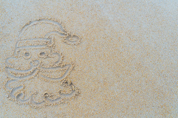 Concept Christmas on the beach Tropical design made in Phuket, Thailand Write the alphabet on the sand background Taken from real locations.