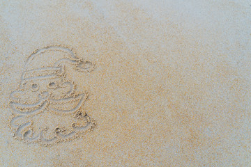 Concept Christmas on the beach Tropical design made in Phuket, Thailand Write the alphabet on the sand background Taken from real locations.
