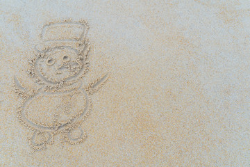 Concept Christmas on the beach Tropical design made in Phuket, Thailand Write the alphabet on the sand background Taken from real locations.