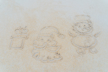 Concept Christmas on the beach Tropical design made in Phuket, Thailand Write the alphabet on the sand background Taken from real locations.