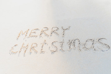 Concept Christmas on the beach Tropical design made in Phuket, Thailand Write the alphabet on the sand background Taken from real locations.