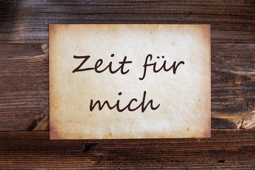 Old Grungy Paper With German Text Zeit Fuer Mich Means Time For Me. Wooden Background