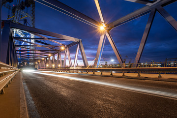 night traffic lights inside of steel bridge	