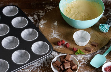 The process of baking delicious muffins with berries, white cream, chocolate.