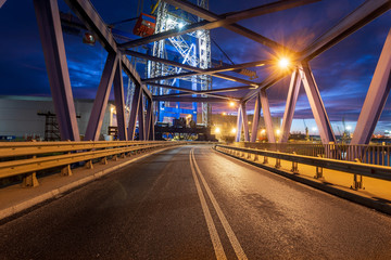 Fototapeta na wymiar night traffic lights inside of steel bridge 