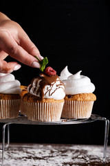 The process of baking delicious muffins with berries, white cream, chocolate.