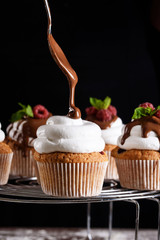 The process of baking delicious muffins with berries, white cream, chocolate.