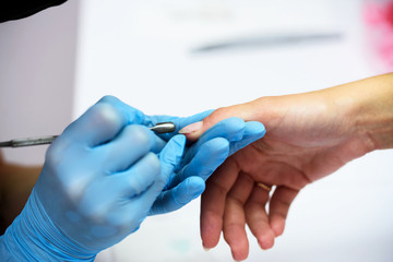 Manicure process in beauty salon, close up