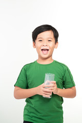 Portrait of a cute schoolboy with a glass of milk