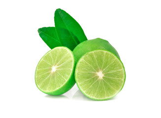 Close-up of Fresh whole limes with slices and leaves isolated on white background with clipping path.