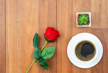 Fototapeta na wymiar White cup of coffee and red rose valentine concept