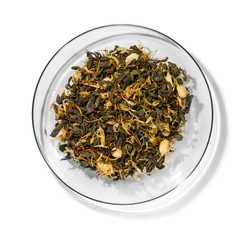 Green tea with aromatic additives. Top view on white background
