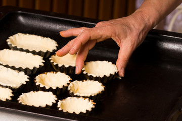 raw tartlets on oven sheet