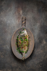 Fried whole fish asian style with oil and green onion, copy space