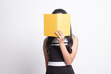 Young Asian woman with a book cover her face