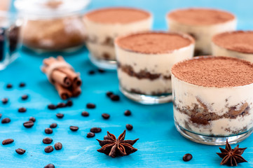 tiramisu in a glass decorated with coffee beans on a dark background