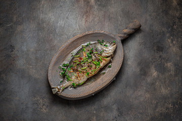 Fried whole fish asian style with oil and green onion, copy space