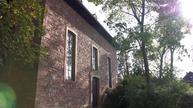 German curch in the woods with lens flare