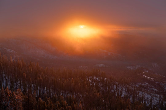 Sunset over misty mountain forest 