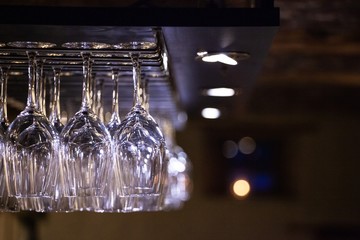 wine glasses hanging above bar