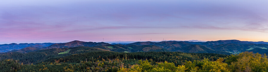 Germany, XXL panorama of endless untouched black forest nature landscape, hills and mountains under red glowing sky after sunset, aerial view above - obrazy, fototapety, plakaty