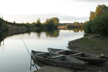 Fototapeta na wymiar Two boats on the a bank of the river Seim in Ukraine