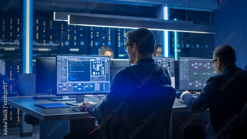 Poster Team of IT Programers Working on Desktop Computers in Data Center Control Room. Young Professionals Writing on Sophisticated Programming Code Language