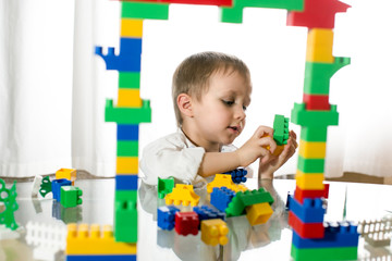 little boy playing with toy blocks