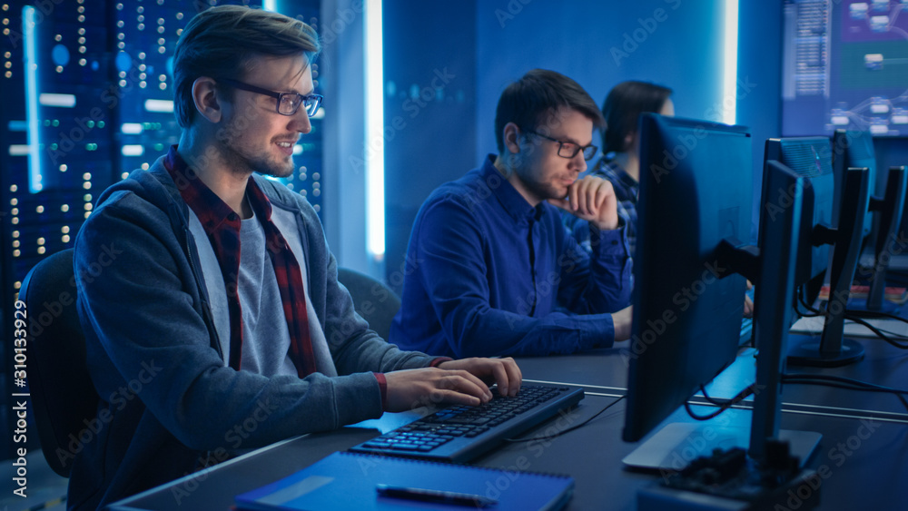 Poster Team of Young IT Programers Working on Desktop Computers in Data Center System Control Room. Displays Show Concept: Software Development / Code Writing / Database Architecture. Technical Department