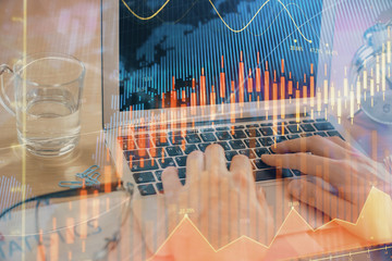 Multi exposure of market chart with man working on computer on background. Concept of financial analysis.