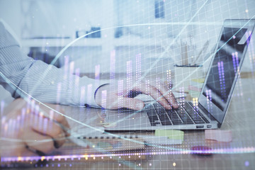 Multi exposure of stock market chart with man working on computer on background. Concept of financial analysis.