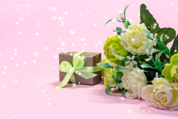 Bouquet of flowers and gift boxes on pink festive light magic background. Concept Valentine's day, mother's holiday, wedding or March 8 greeting card
