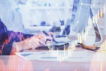 Forex graph with businessman working on computer in office on background. Concept of hardworking. Closeup. Multi exposure.