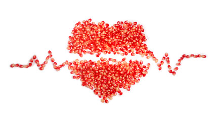 Pomegranate seeds isolated on white. Heart symbol.