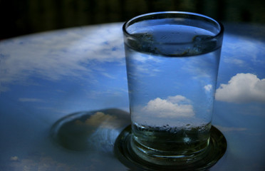 glass of water with ice on blue background