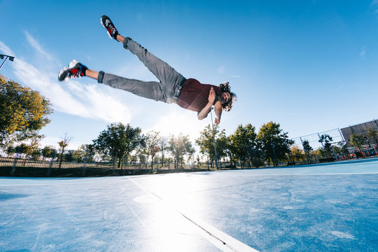 Parkour man doing tricks on the street - Free runner training his acrobatic port outdoors
