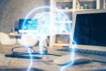 Double exposure of table with computer and brain hologram. Data innovation concept.