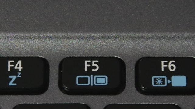 A finger hitting F5 button to refresh page on notebook keyboard