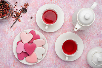 Heart shape cookies with icing with berry tea. Concept: Valentine's Day tea party, festive table setting in pink.